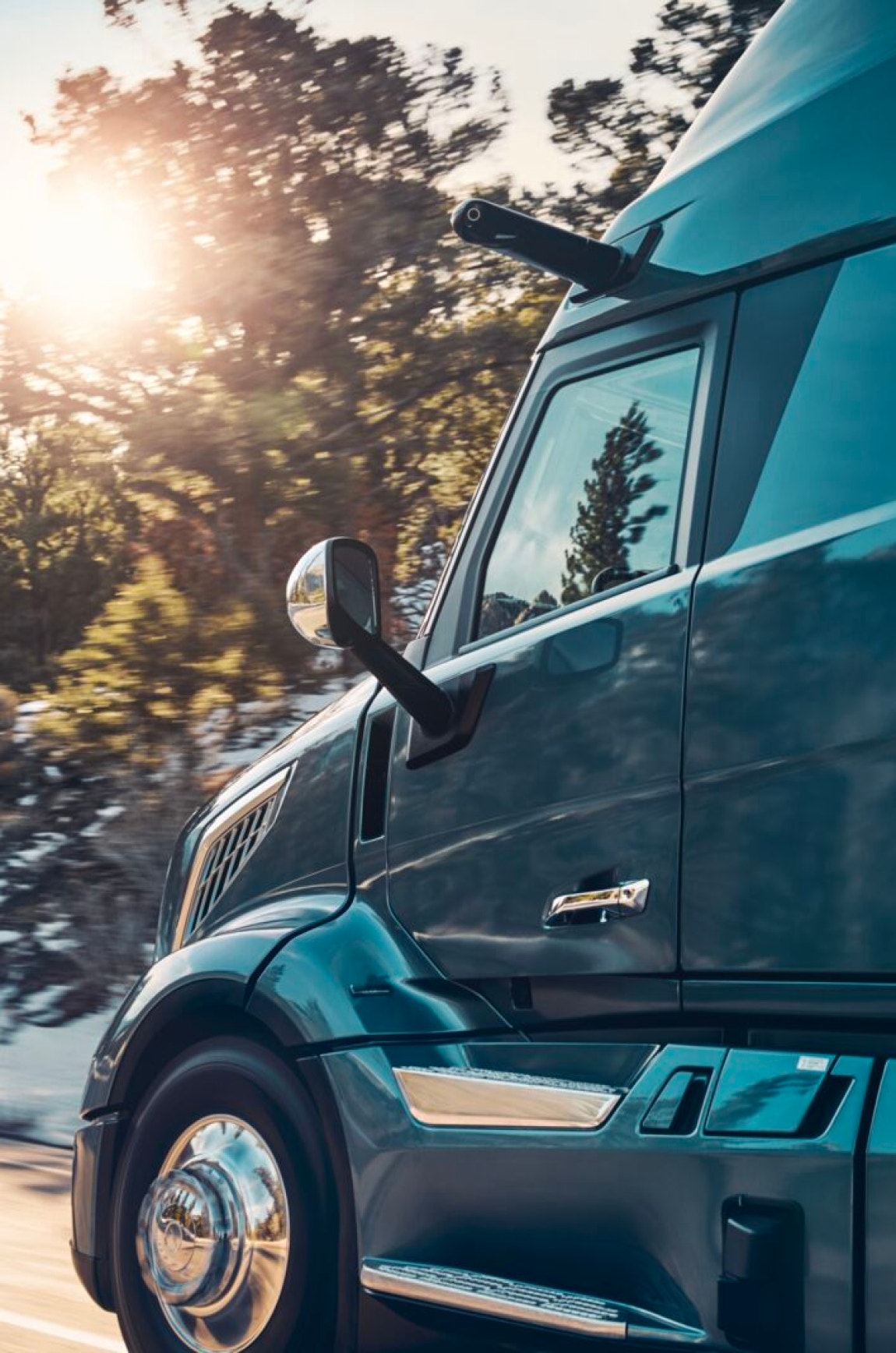 Side view of a truck cab highlighting chrome details and aerodynamic design